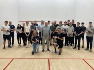 Players assembled on court with trophies